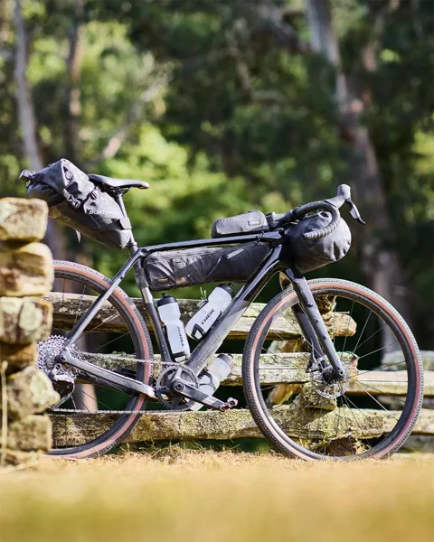 Adventure gravel bike leaning against a post