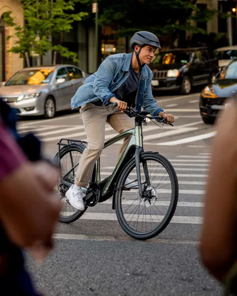 Man riding a hybrid bike through the city