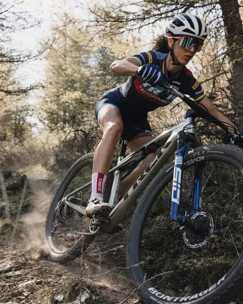 Woman riding a mountain bike down hill