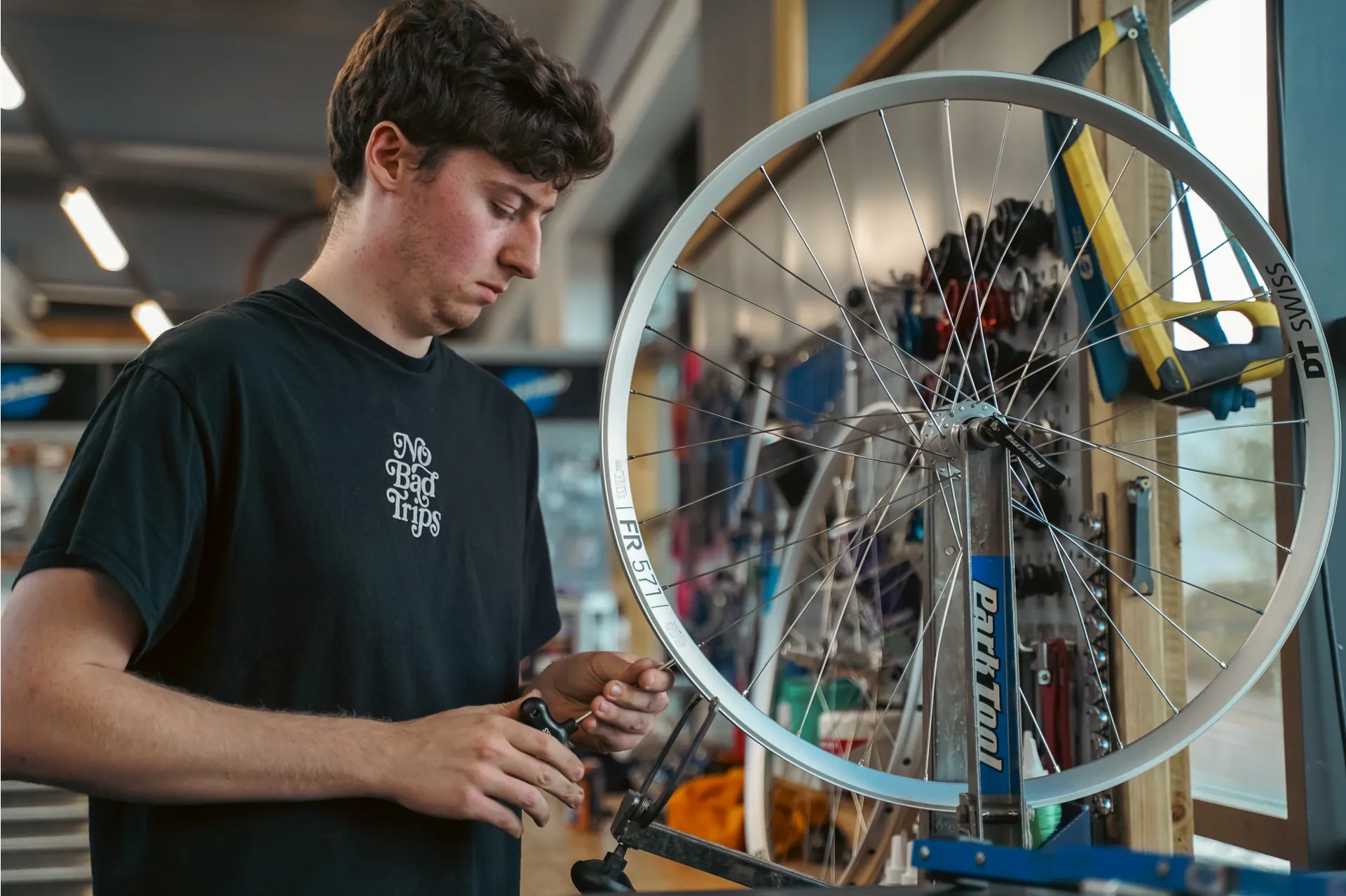 Workshop mechanic building a bike wheel