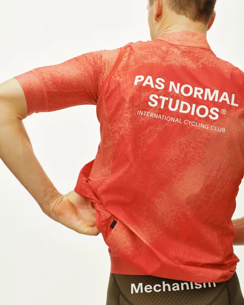 Pas Normal Studios Mechanism Stow Away Gilet in AOP Hibiscus Orange-6